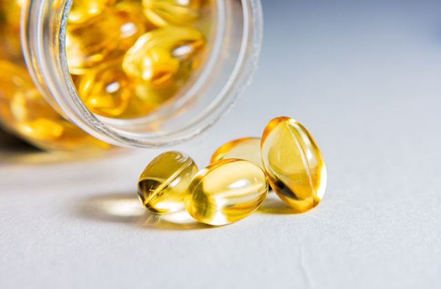 Golden softgel supplement capsules