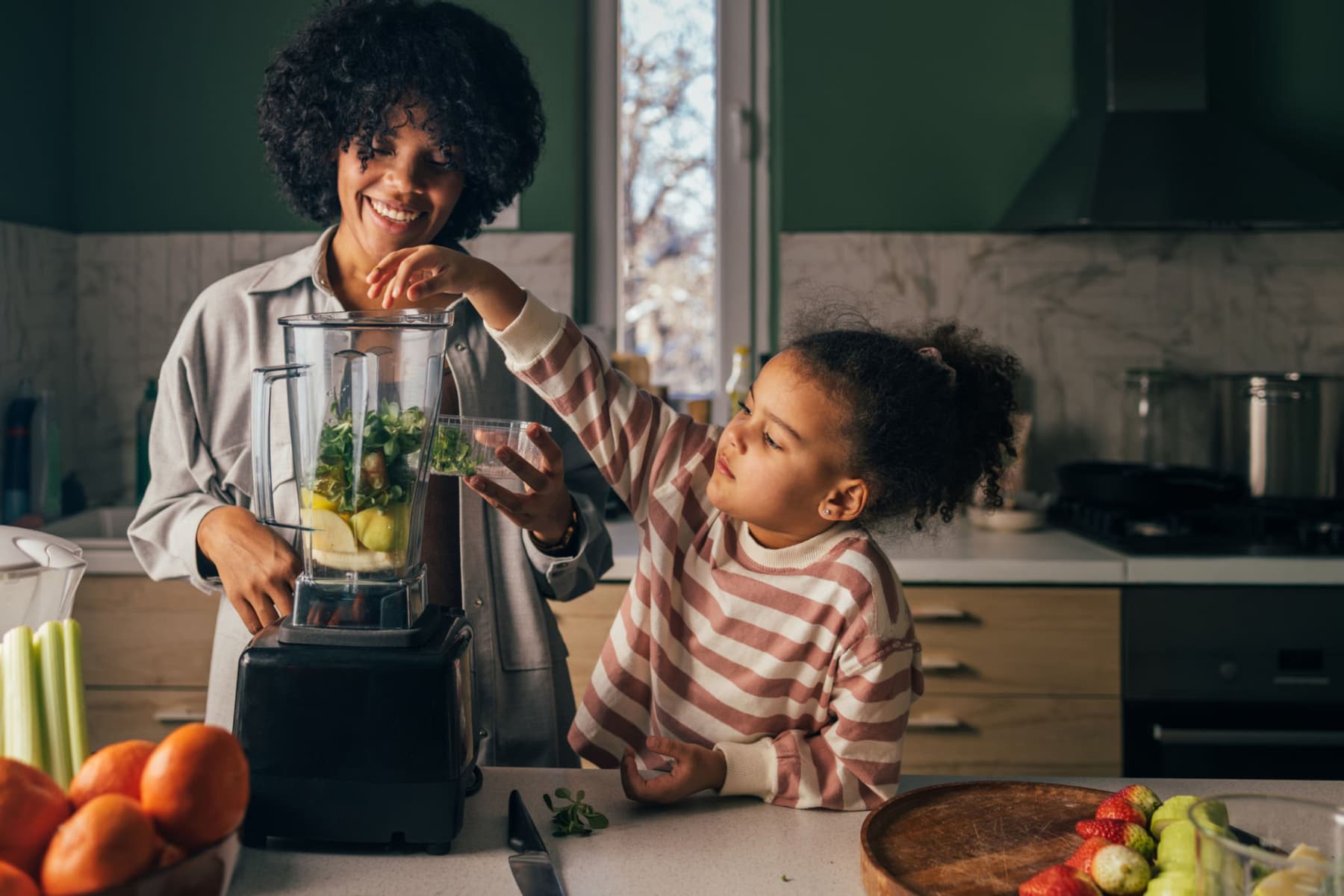 A parent and child preparing food together